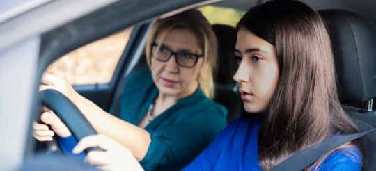 Mother instructing teen driver